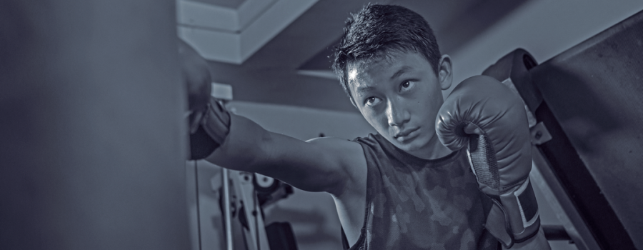 A young man punching a boxing bag