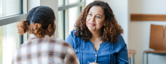 An adult woman talking with a teenager