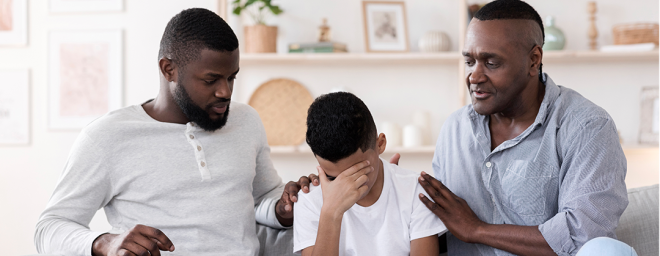 Two parents comforting child