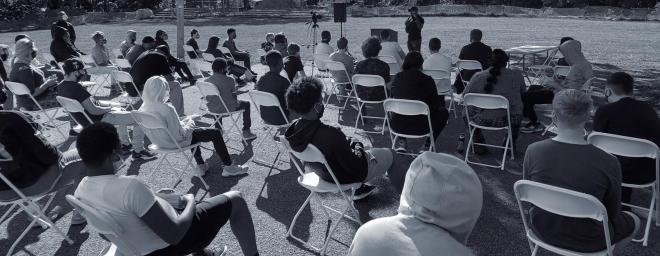 Chris Wilson giving a lecture outside to Nexus-Woodbourne youth