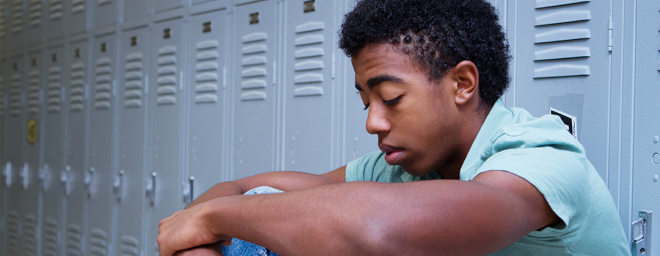 Struggling Teenage boy at school