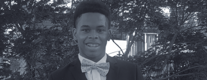 Josh, a Black teenage boy, dressed in a tuxedo for a school dance.
